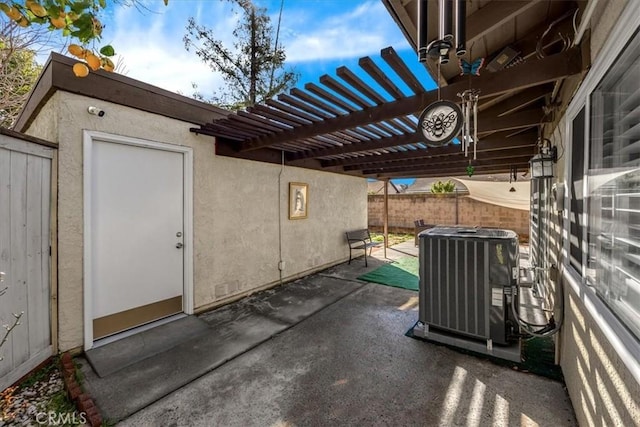 view of patio / terrace with cooling unit, a pergola, and fence