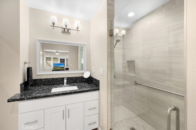 bathroom featuring a shower stall and vanity