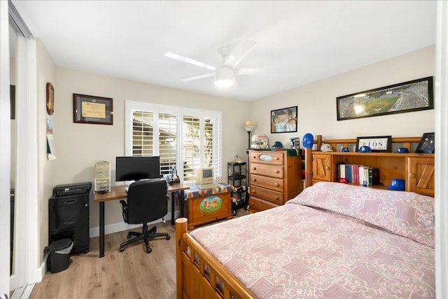 bedroom featuring light wood finished floors, ceiling fan, and baseboards