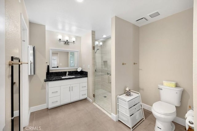 full bathroom featuring vanity, a shower stall, toilet, and baseboards