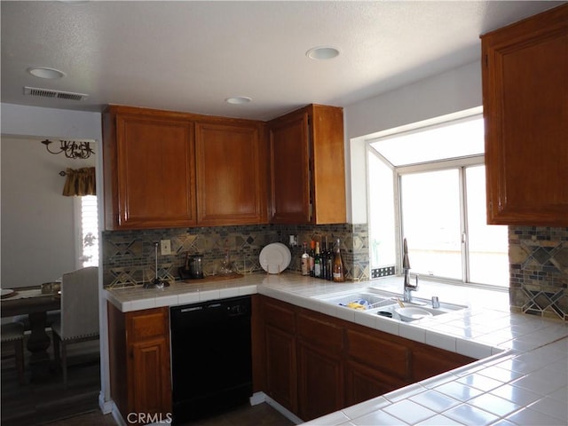 10402 Via Pajaro, Moreno Valley, CA 92557 - kitchen with visible vents, black dishwasher, tasteful backsplash, a sink, and brown cabinetry