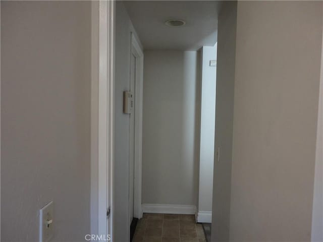 10402 Via Pajaro, Moreno Valley, CA 92557 - corridor featuring baseboards and dark tile patterned floors