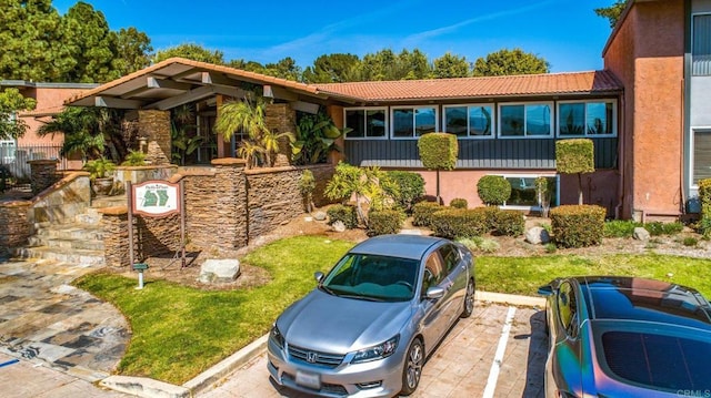 view of front of property with stucco siding and a tiled roof