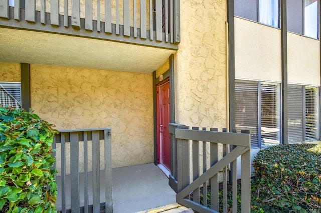 view of exterior entry with stucco siding