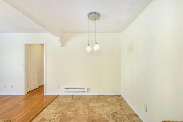 spare room with light wood finished floors, a baseboard heating unit, and baseboards