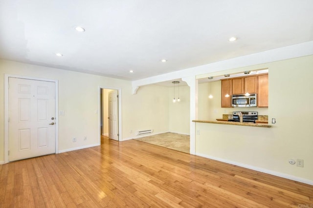 unfurnished living room featuring light wood finished floors, recessed lighting, and baseboards