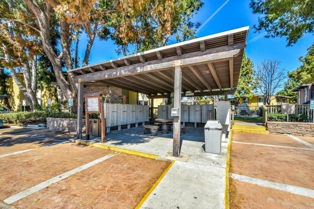 view of vehicle parking featuring mail area