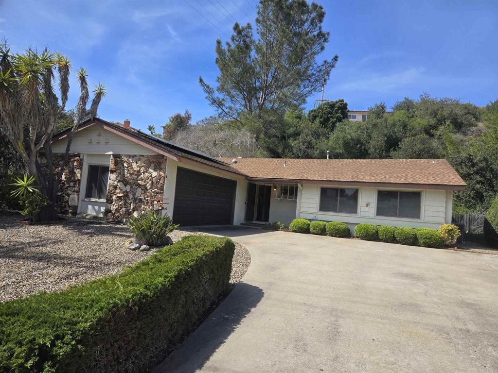 ranch-style home with an attached garage and driveway