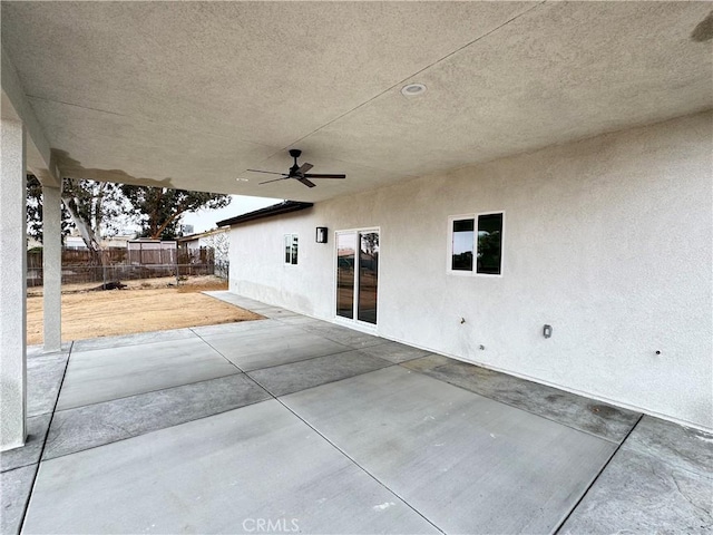 view of patio with fence and ceiling fan