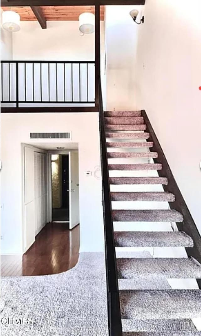 5460 White Oak Ave Unit C339, Los Angeles, CA 91316 - stairs with wood finished floors, a towering ceiling, and beamed ceiling