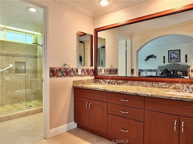 full bathroom with tile patterned flooring, crown molding, a shower stall, and a sink