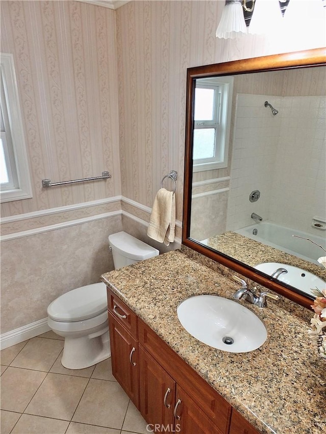 full bathroom featuring toilet, shower / washtub combination, tile patterned flooring, wallpapered walls, and vanity