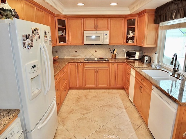 kitchen with white appliances, light stone counters, ornamental molding, and a sink