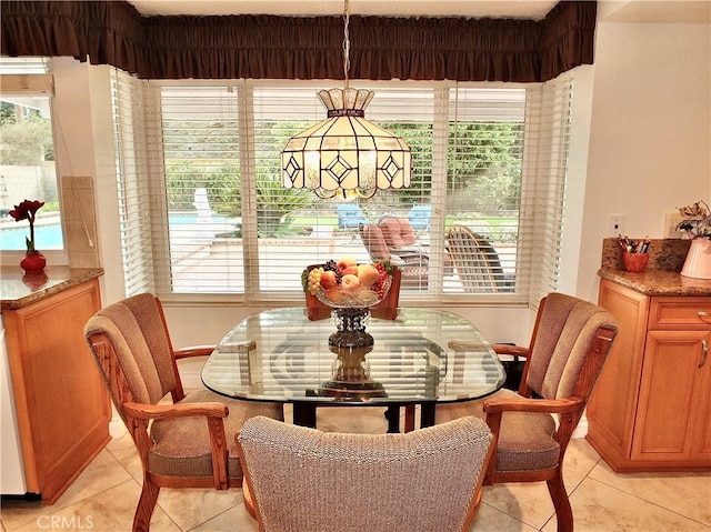 dining space featuring light tile patterned floors and breakfast area