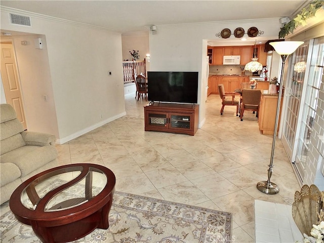 living room featuring light tile patterned floors, visible vents, baseboards, and ornamental molding