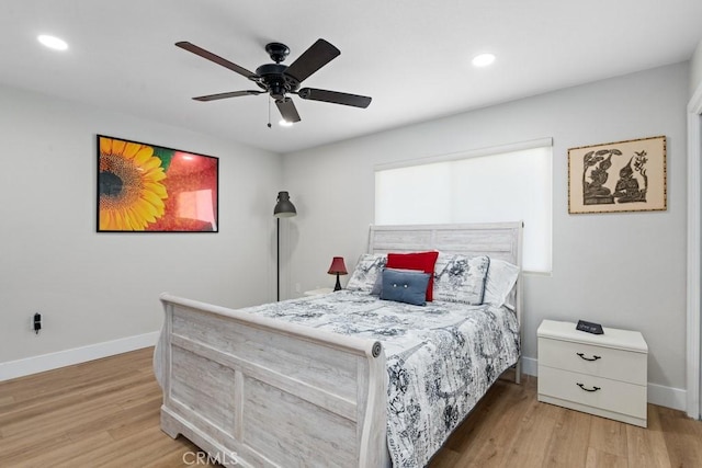 bedroom with recessed lighting, wood finished floors, and baseboards