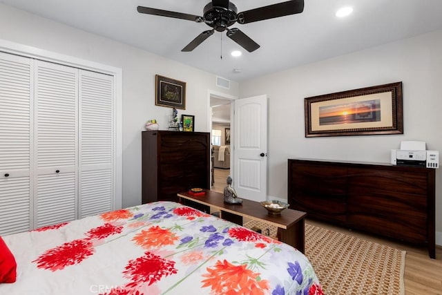 bedroom with a closet, visible vents, recessed lighting, and light wood finished floors