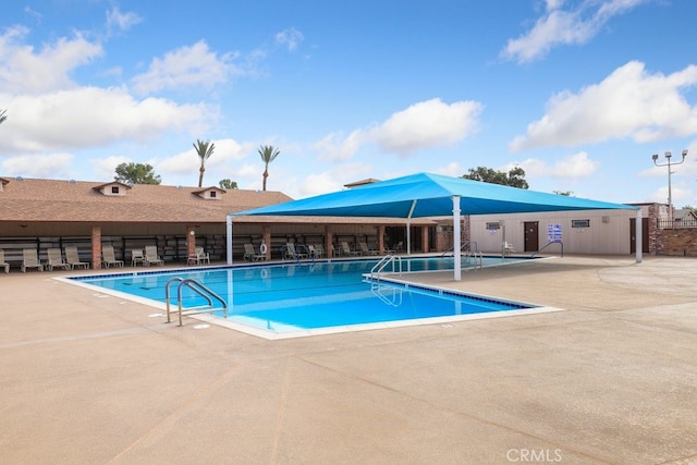 community pool featuring a patio area and fence