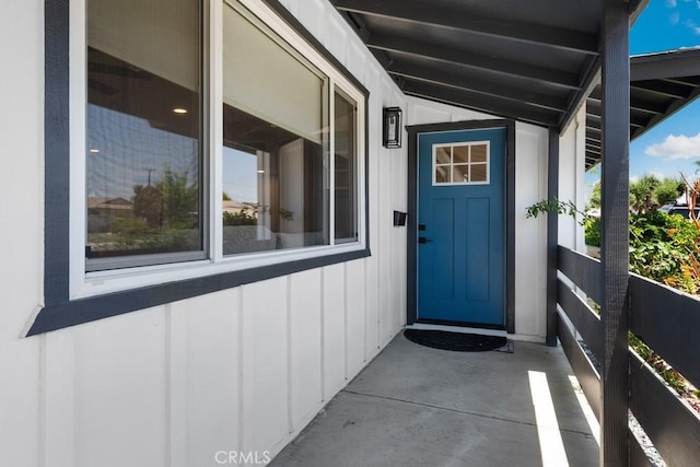 view of exterior entry with board and batten siding