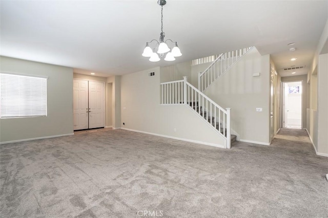 unfurnished living room featuring stairway, visible vents, baseboards, carpet floors, and a notable chandelier