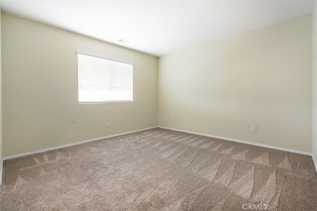 carpeted empty room with baseboards