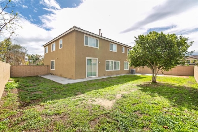 rear view of house with a yard, central air condition unit, stucco siding, and a fenced backyard