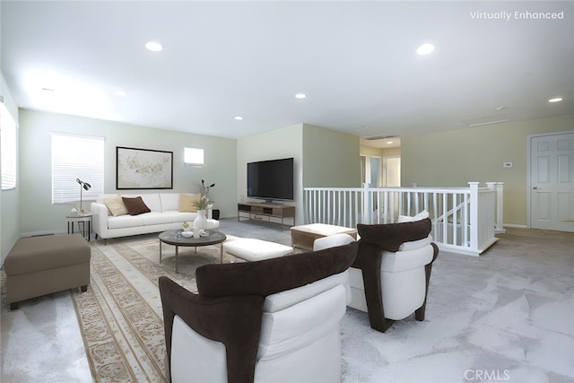 living area featuring recessed lighting, baseboards, and light colored carpet