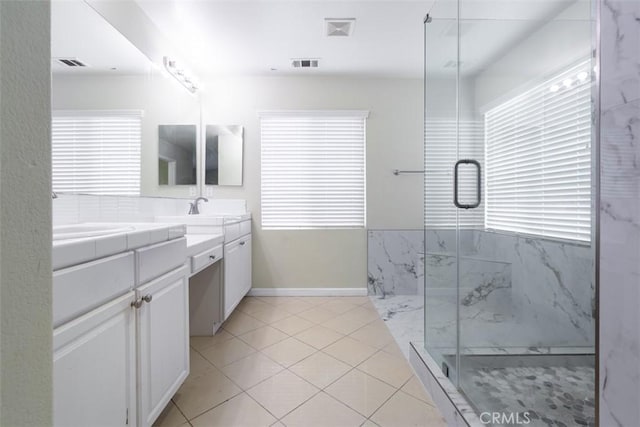 bathroom featuring a marble finish shower, visible vents, a sink, and double vanity