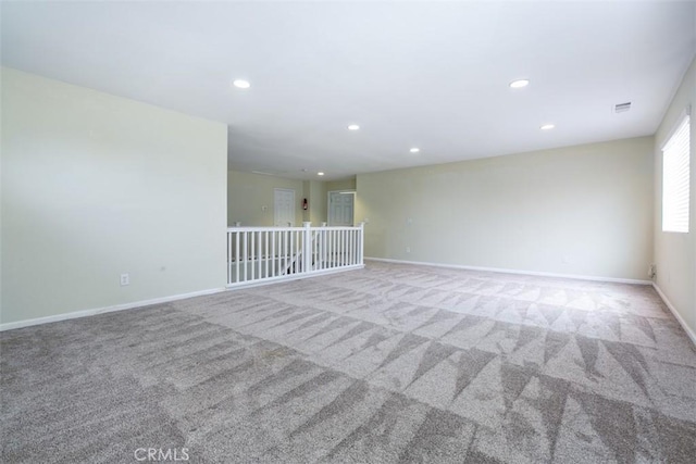 carpeted spare room with recessed lighting and baseboards