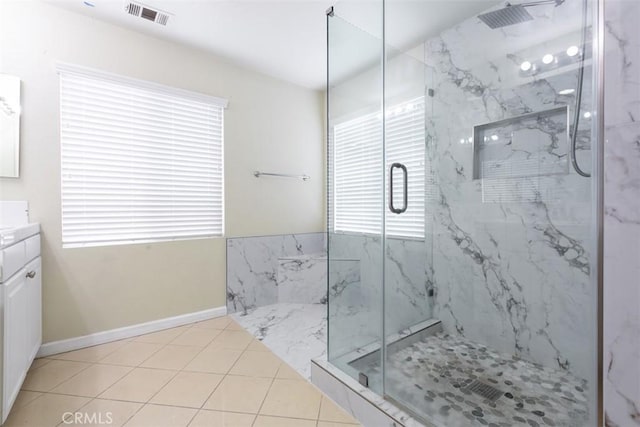 bathroom with vanity, tile patterned floors, visible vents, and a marble finish shower