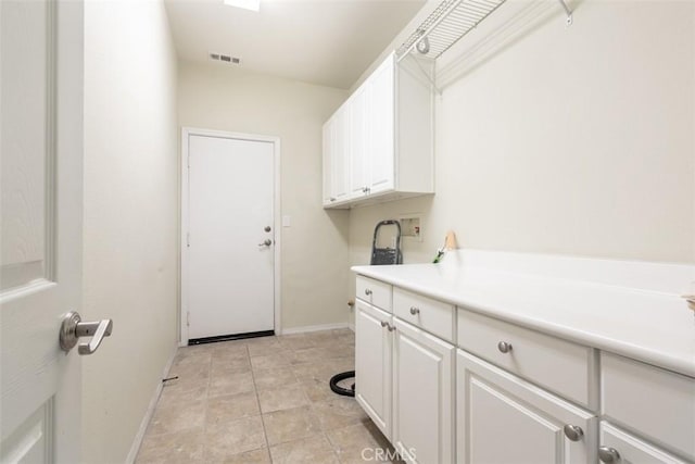 laundry room with visible vents, baseboards, light tile patterned floors, hookup for a washing machine, and cabinet space