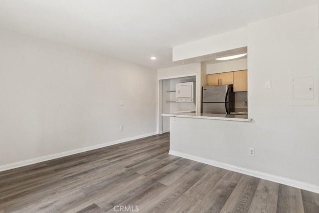 unfurnished living room featuring recessed lighting, baseboards, and dark wood-style flooring