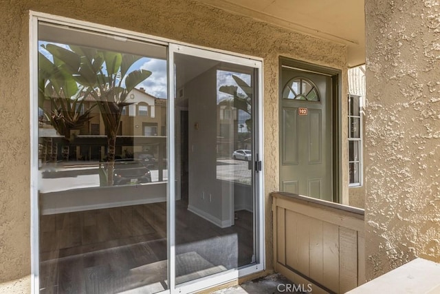 doorway to property with stucco siding