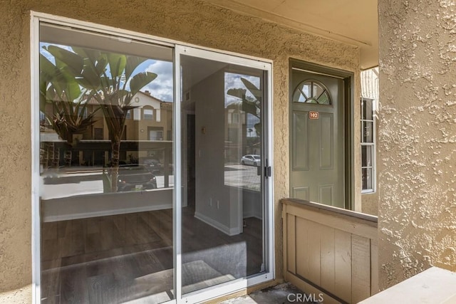 entrance to property with stucco siding