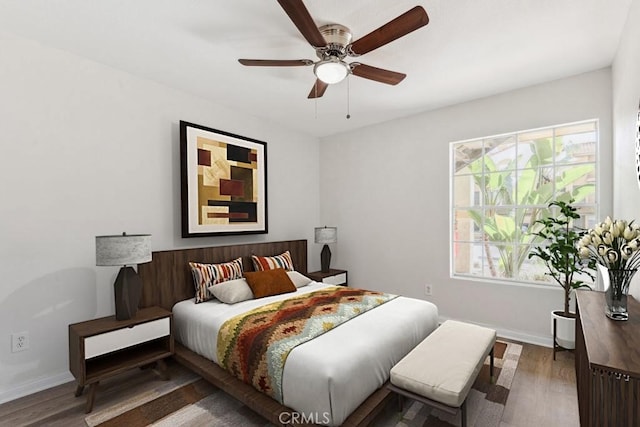 bedroom featuring baseboards, wood finished floors, and a ceiling fan