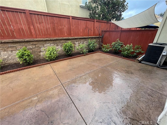 view of patio / terrace with a fenced backyard and central AC