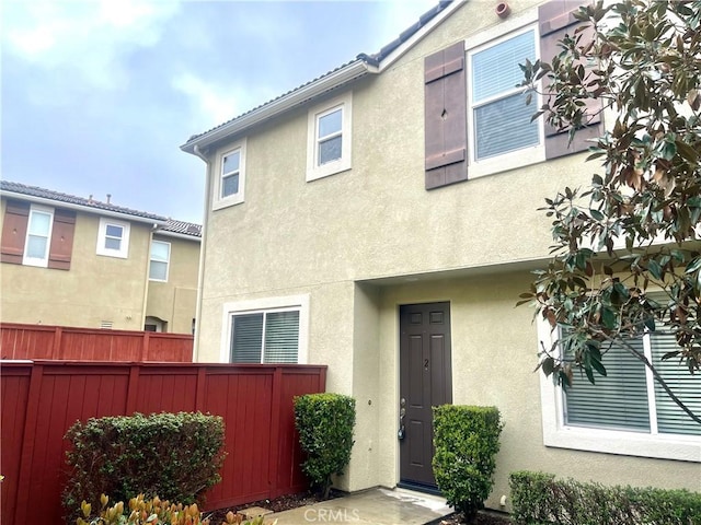 exterior space with fence and stucco siding