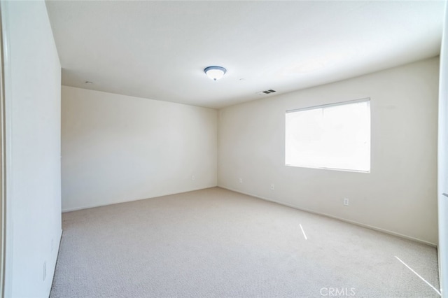 empty room featuring carpet and visible vents