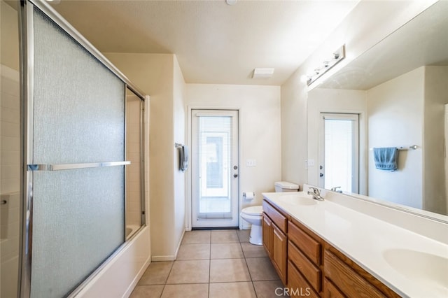 full bath featuring tile patterned floors, double vanity, toilet, and a sink