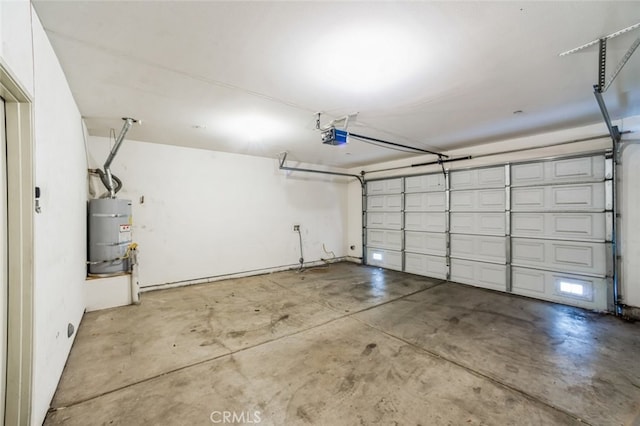 garage featuring strapped water heater and a garage door opener