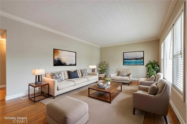 living room featuring ornamental molding, baseboards, and wood finished floors