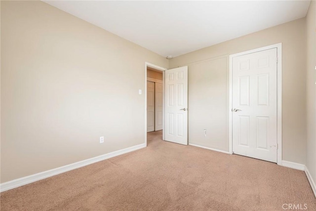 unfurnished bedroom with baseboards and carpet floors