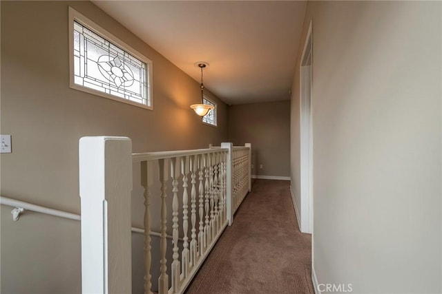 corridor featuring an upstairs landing, carpet, and baseboards