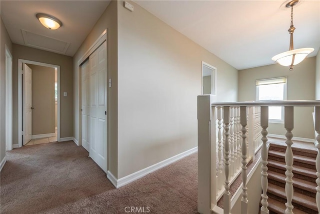 hall featuring baseboards and carpet floors