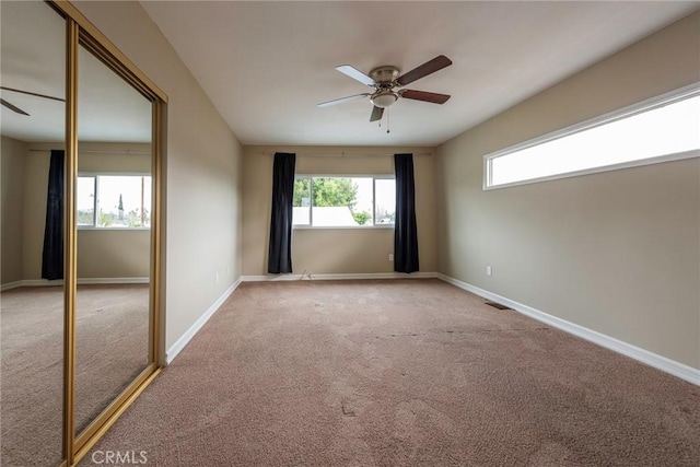 spare room with visible vents, baseboards, a ceiling fan, and carpet floors