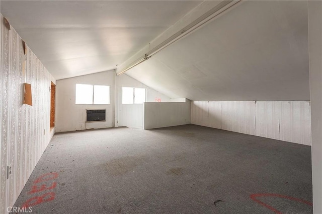 bonus room with heating unit, carpet flooring, a fireplace, and lofted ceiling