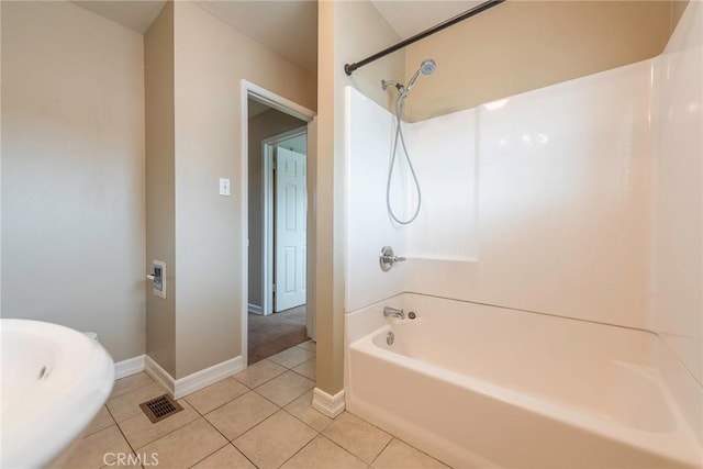 full bath featuring tile patterned floors, visible vents, washtub / shower combination, and baseboards