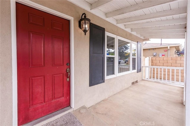 property entrance featuring stucco siding and a porch