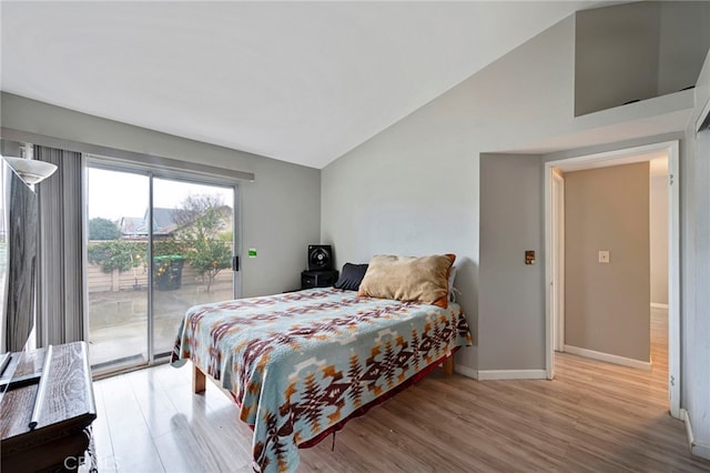 bedroom featuring vaulted ceiling, access to outside, light wood-style floors, and baseboards