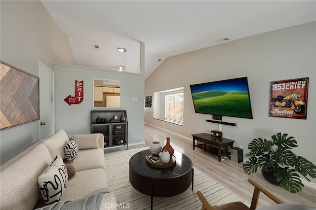 living room with visible vents, wood finished floors, and vaulted ceiling